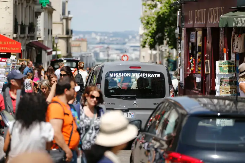 A car, part of  Operation Vigipirate , patrols in the Montmartre neighbourhood of Paris on July 15, 2016, a day after the attack in Nice. A Tunisian-born man zigzagged a truck through a crowd celebrating Bastille Day in the French city of Nice, killing at least 84 and injuring dozens of children in what President Francois Hollande on July 15 called a  terrorist  attack.