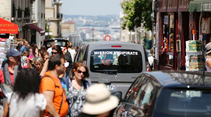 A car, part of  Operation Vigipirate , patrols in the Montmartre neighbourhood of Paris on July 15, 2016, a day after the attack in Nice. A Tunisian-born man zigzagged a truck through a crowd celebrating Bastille Day in the French city of Nice, killing at least 84 and injuring dozens of children in what President Francois Hollande on July 15 called a  terrorist  attack.