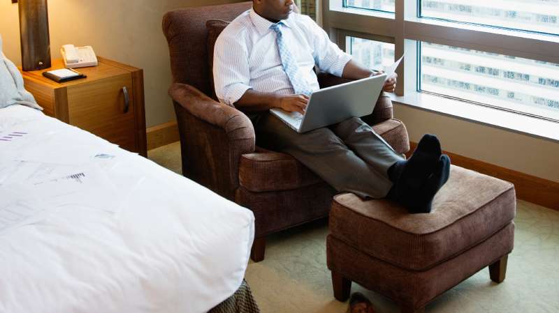 man on laptop in hotel room
