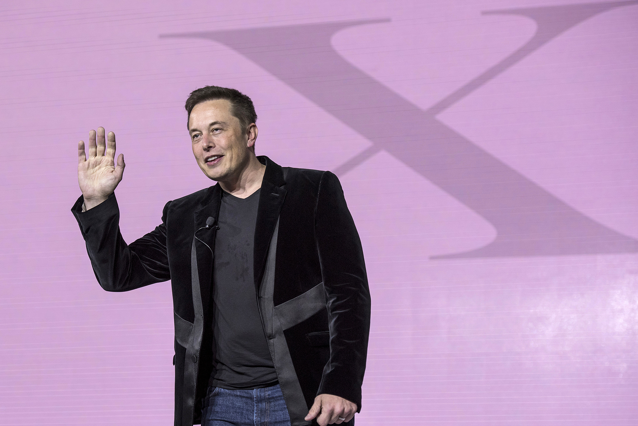 Elon Musk, chairman and chief executive officer of Tesla Motors Inc., gestures as he unveils the Model X sport utility vehicle (SUV) during an event in Fremont, California, on Sept. 29, 2015.