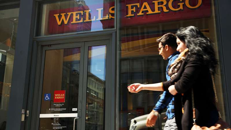 Pedestrians pass a Wells Fargo bank branch in lower Manhattan on April 15, 2016 in New York City.