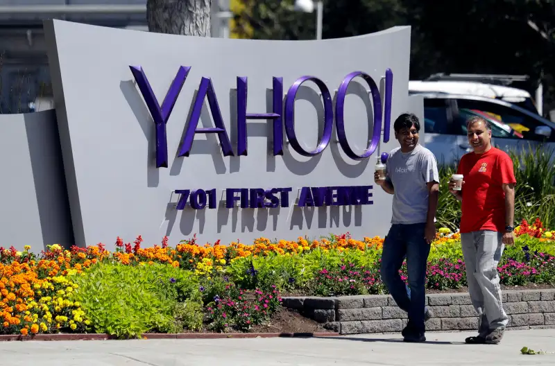 People walk past the Yahoo sign at the company's headquarters July 19, 2016, in Sunnyvale, Calif.