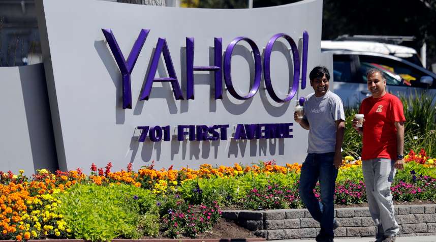 People walk past the Yahoo sign at the company's headquarters July 19, 2016, in Sunnyvale, Calif.