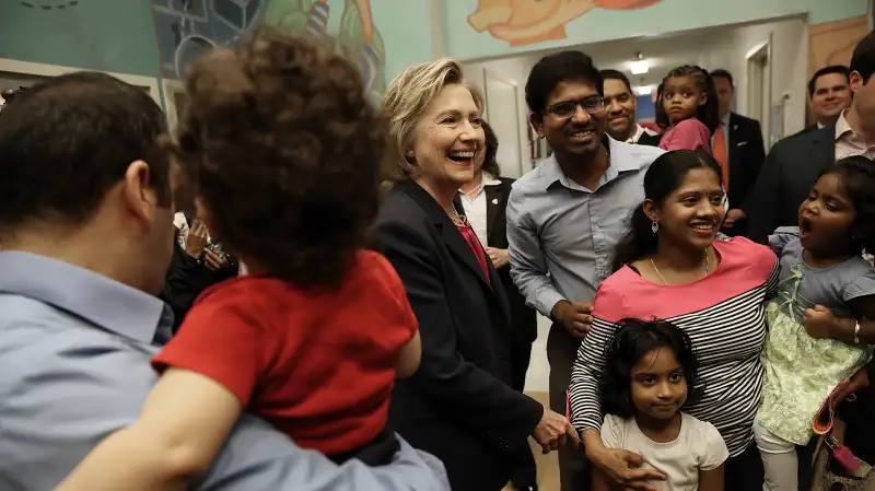 Democratic presidential candidate and former U.S. Secretary of State Hillary Clinton greets students and parents at a KinderCare daycare center May 9, 2016 in Fairfax, Virginia. Clinton's campaign stops in Virginia today were a continuation of her  Breaking Down Barriers  tour highlighting her policies on affordable child care, paid family leave and health care.