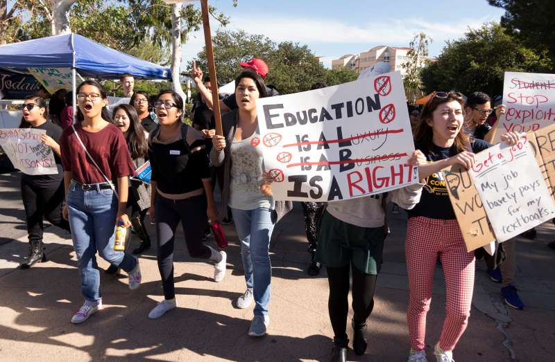 University of California, Irvine students hold signs in protest of high education costs during the Million Student March in Irvine, California, USA, 12 November 2015. Students at nearly 110 college campuses were calling for the cancellation of all student debt and tuition-free public colleges.