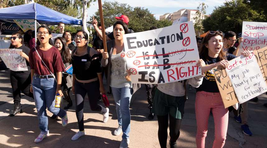 University of California at Irvine students hold signs in protest of high education costs during the Million Student March in Irvine, Calif., on Nov. 12, 2015.