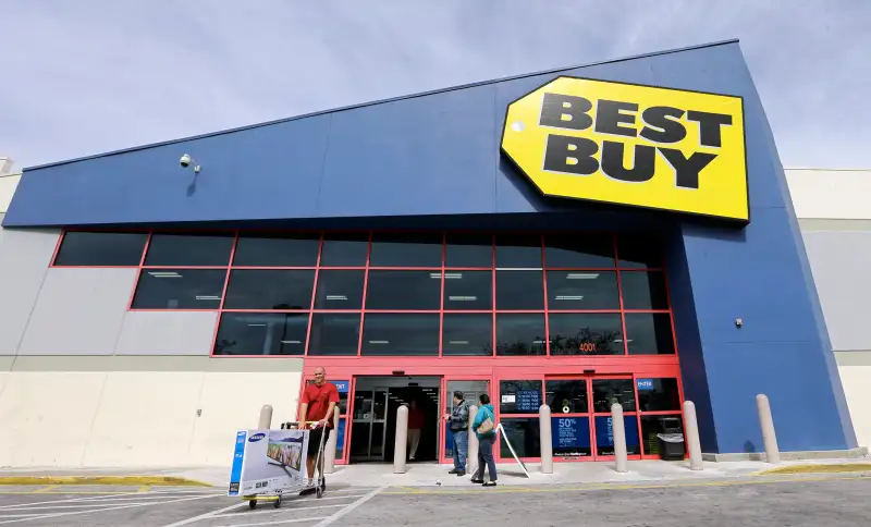 In this Feb. 9, 2016 photo, a shopper carts his purchased LED TV at a Best Buy in Miami.