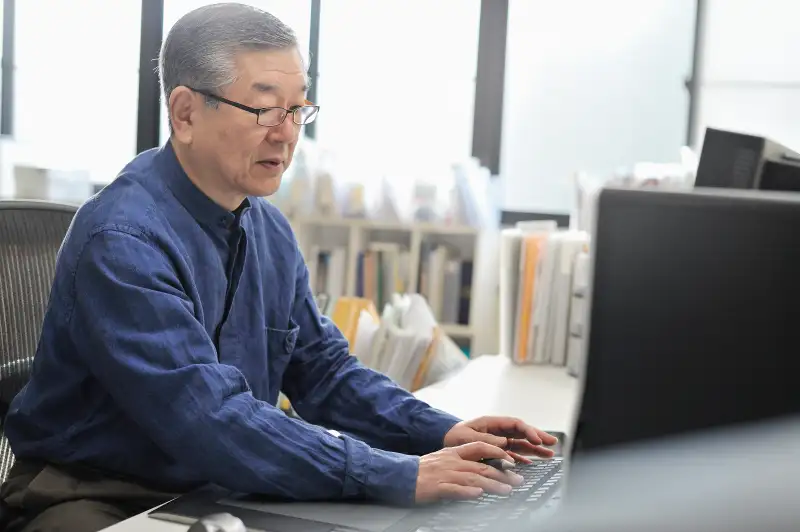 Senior man working on a computer in the office