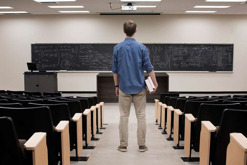 Caucasian student standing in classroom