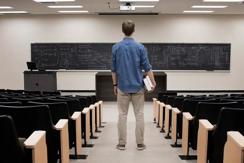 Caucasian student standing in classroom