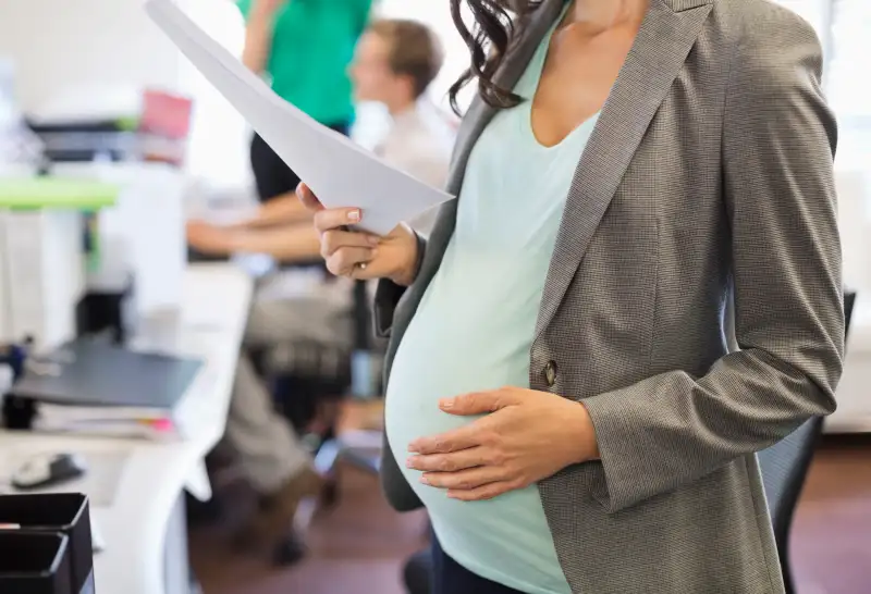 Pregnant businesswoman working in office