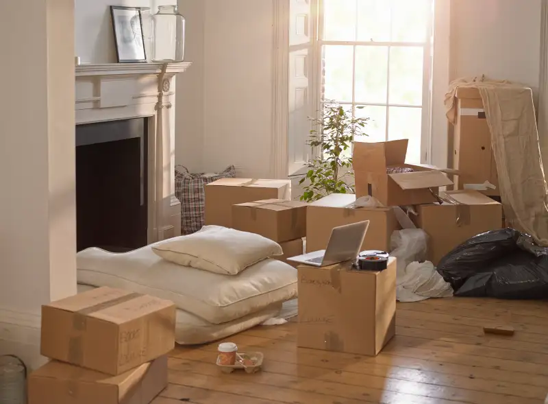 A room full of packing boxes and a laptop