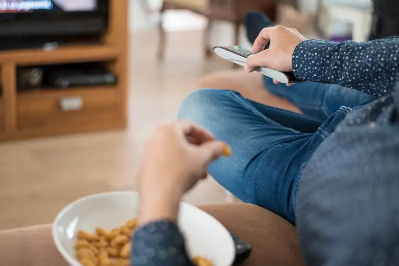 Man using TV remote control