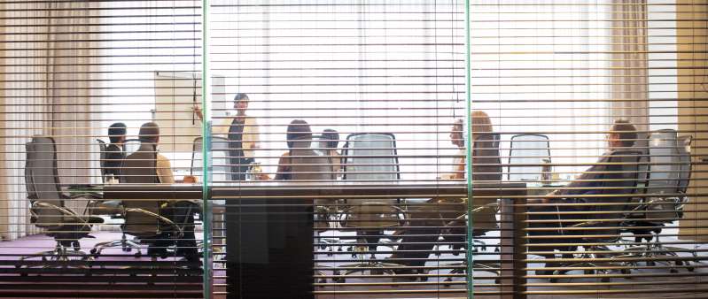 Business people watching presentation in conference room