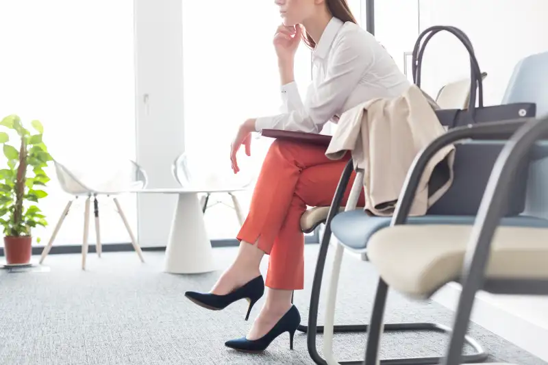 Businesswoman waiting with legs crossed in lobby