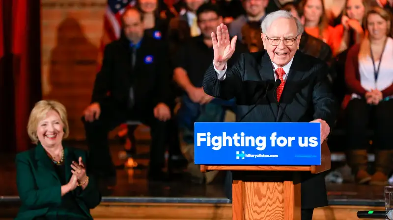 Democratic presidential candidate Hillary Clinton listens as billionaire investor Warren Buffett speaks at a Clinton Grassroots Organizing Event in Omaha, Nebraska, Dec. 16, 2015.