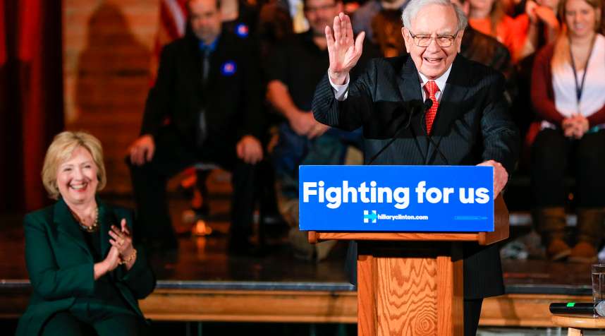 Hillary Clinton listens as billionaire investor Warren Buffett speaks at a 2015 event  in Omaha, Neb.