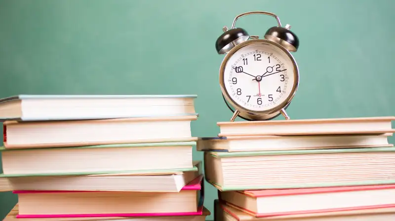 clock on top of books