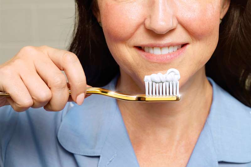 woman with toothbrush and toothpaste