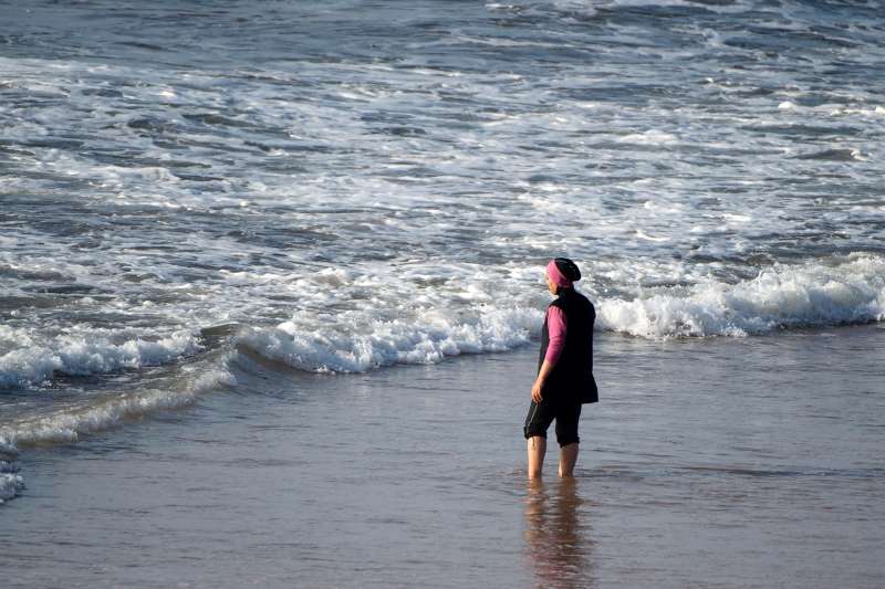 A woman wearing a  burkini , a full-body swimsuit designed for Muslim women.