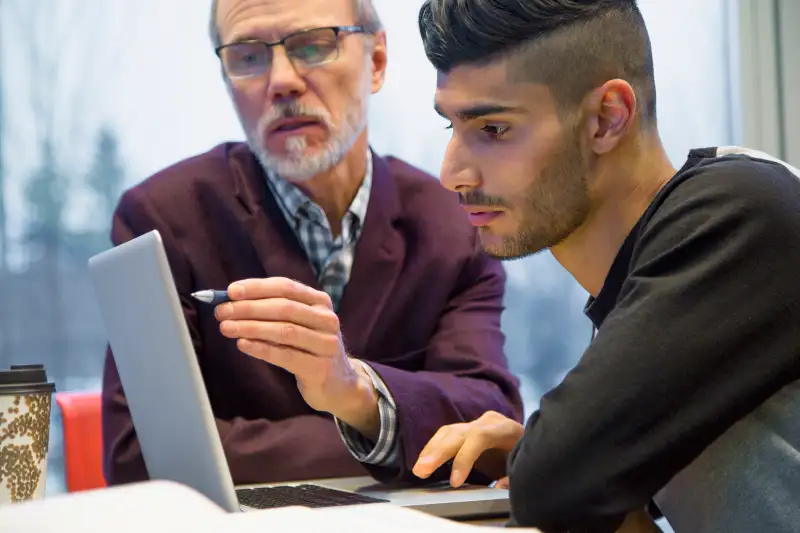 Father and son at computer