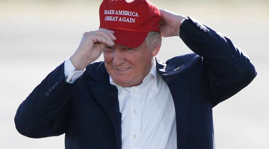 In this June 1, 2016, file photo, Republican presidential candidate Donald Trump wears his  Make America Great Again  hat at a rally in Sacramento, Calif.