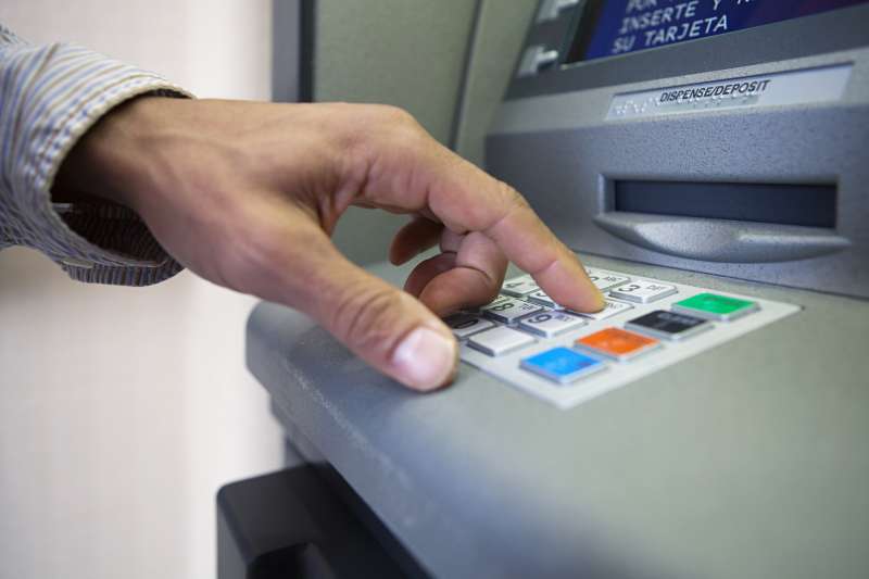 Man using cash machine, close up