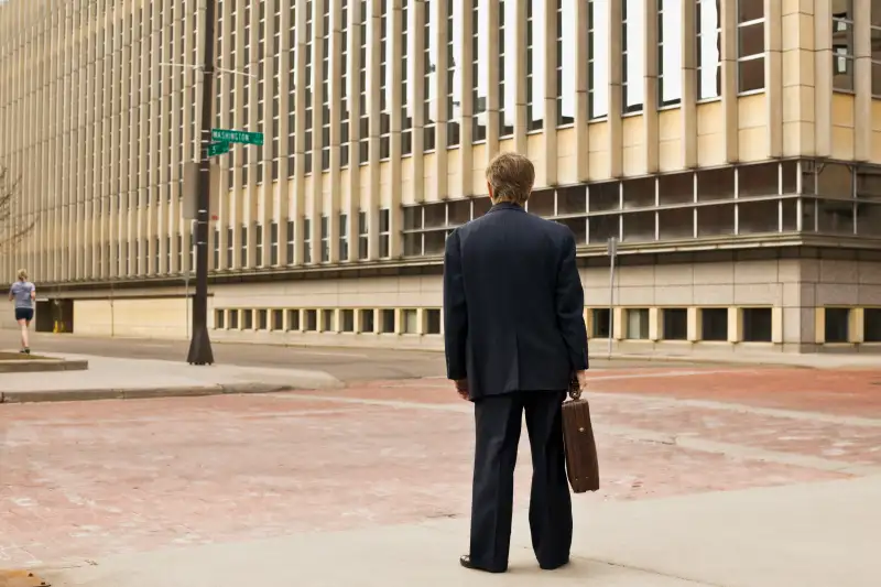 Rear view of a businessman standing with a briefcase