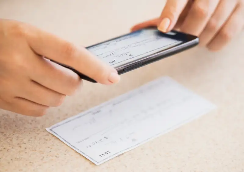 USA, New Jersey, Jersey City, Close up of woman's hand doing online banking with mobile phone