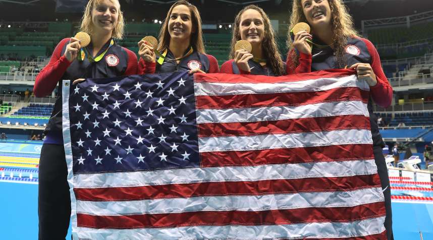 Katie Ledecky, Maya Dirado, Leah Smith and Allison Schimdt of the United States pose with their gold medals from the Women's 4 x 20m Freestyle Relay at the Rio 2016 Olympic Games at the Olympic Aquatics Stadium on August 10, 2016 in Rio de Janeiro, Brazil. (Photo by Ian MacNicol/Getty Images)