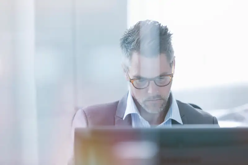 Focused businessman using computer in office