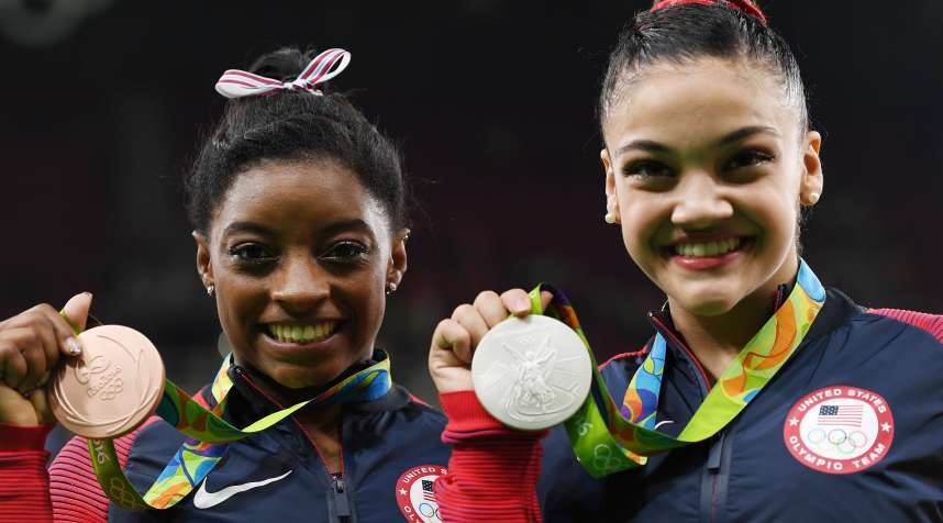 Olympic medalists like Simone Biles (left) and Lauren Hernandez (right) would be taxed on their Olympic medal bonuses under current law.