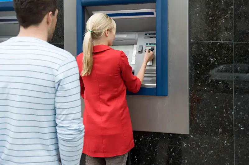 Woman using cash machine