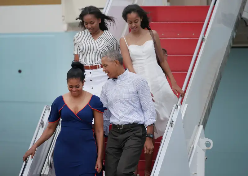 President Barack Obama, First Lady Michelle Obama, and their daughters, Sasha, back left, and Malia, step off Air Force One at Joint Base Cape Cod to take Marine One to Martha's Vineyard for a vacation, on Aug. 6, 2016.