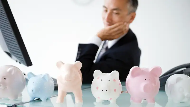 piggy banks lined up on office desk