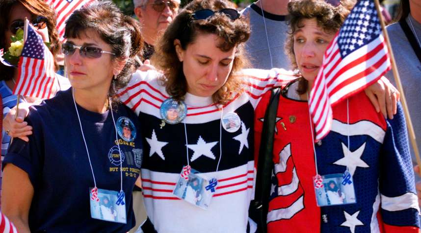 Three women embrace as they march to the  Ground Zero  site of the
                      World Trade Center disaster with family members and friends of victims
                      of the September 11, 2001 attacks on the Trade Center and the Pentagon
                      in New York, September 29, 2002.
