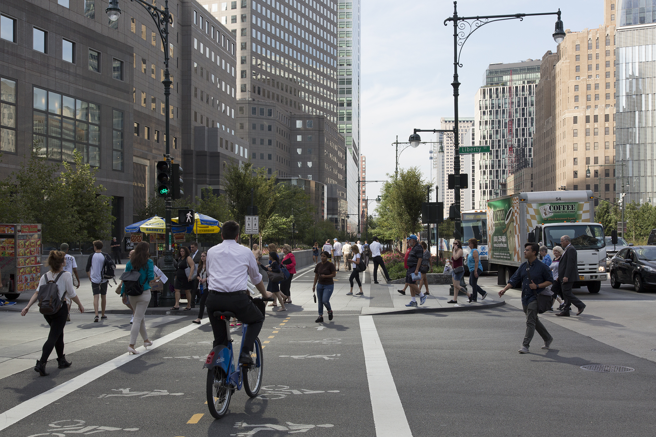 Commuters on the bustling bike path and corner of Liberty and West Streets, New York.