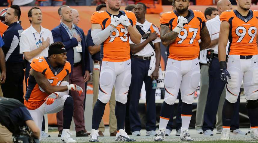 Denver Broncos inside linebacker Brandon Marshall (54) kneels during the National Anthem.