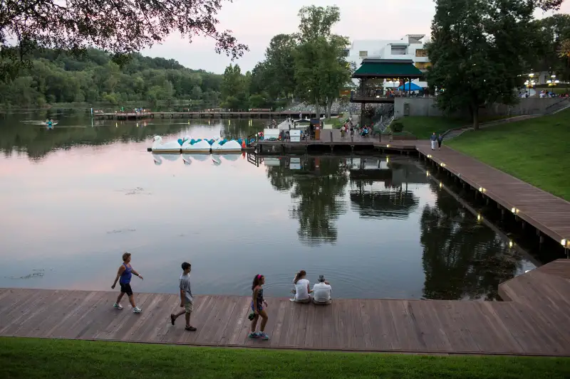 Families walk along the waterfront at Lake Kittamaqundi in Columbia, MD, on Friday, August 19, 2016. Photo by Ackerman + Gruber @ackermangruber