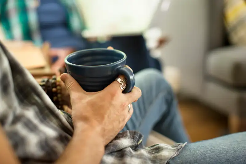 millennial holding coffee cup