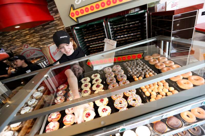 Retail Krew member Rachelle Goebel loads up a box of doughnuts, Krispy Kreme, Toronto, ON.