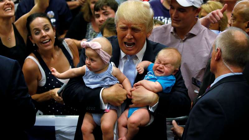 Republican presidential nominee Donald Trump holds babies at a campaign rally in Colorado Springs, Colorado, July 29, 2016.