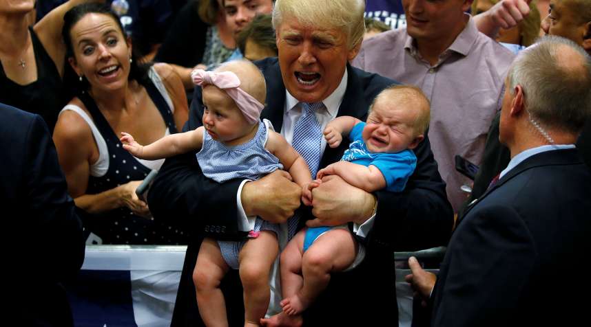 Republican presidential nominee Donald Trump holds babies at a campaign rally in Colorado Springs, Colorado, July 29, 2016.