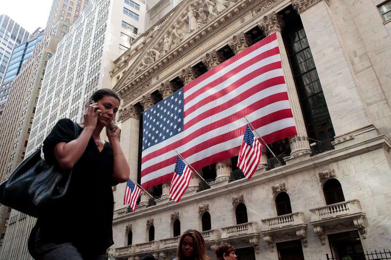 People walk past the New York Stock Exchange, September 13, 2016 in New York City.