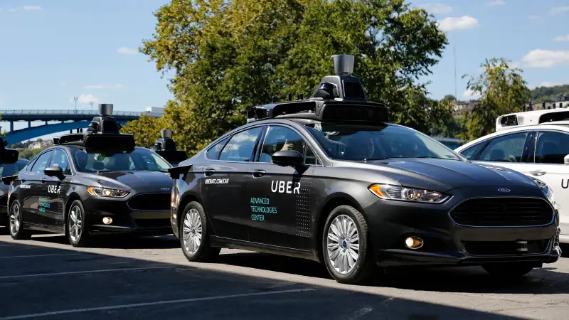 A group of self driving Uber vehicles position themselves to take journalists on rides during a media preview at Uber's Advanced Technologies Center in Pittsburgh, Monday, Sept. 12, 2016.