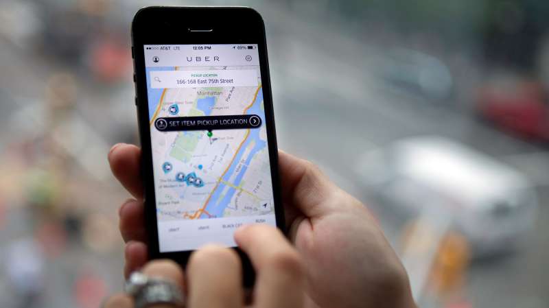 The Uber Technologies Inc. car service application (app) is demonstrated for a photograph on an Apple Inc. iPhone in New York, on Wednesday, Aug. 6, 2014.