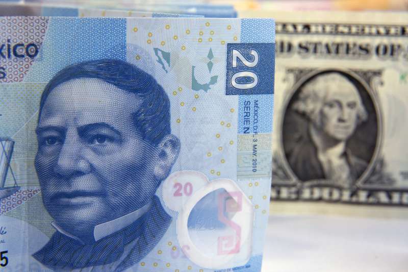 Mexican Peso bills are arranged for a photograph with a U.S. one dollar bill in Mexico City, Mexico, on Wednesday, Jan. 27, 2016. Mexicos peso, the worst performing major currency in 2016, is poised for a rebound by the end of this year, according to its most-accurate forecaster, Sireen Harajli, a strategist for Mizuho Bank Ltd. who was the best analyst for the peso in the fourth quarter, according to a Bloomberg ranking.