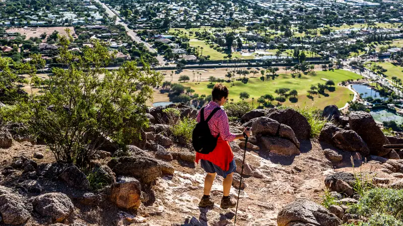 A woman in her mid thirties hiking the Cholla Trail above Scottsdale Arizona.