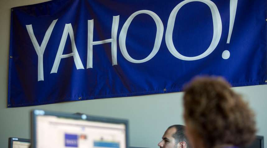 A Yahoo! banner hangs above employees during a training class at the Yahoo! Inc. Customer Care Center of Excellence in Amherst, New York, U.S., on Friday, Sept. 26, 2014.