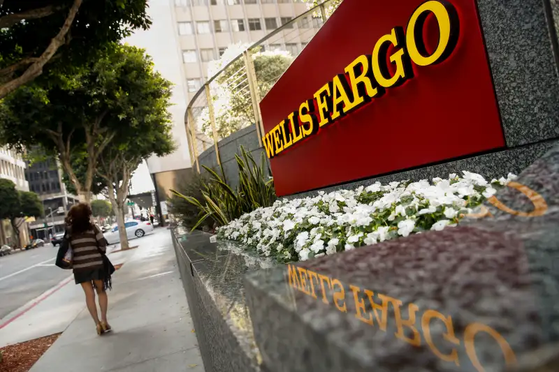 A woman walks past a Wells Fargo & Co. bank branch in Los Angeles, California, U.S., on Tuesday, July 7, 2015.